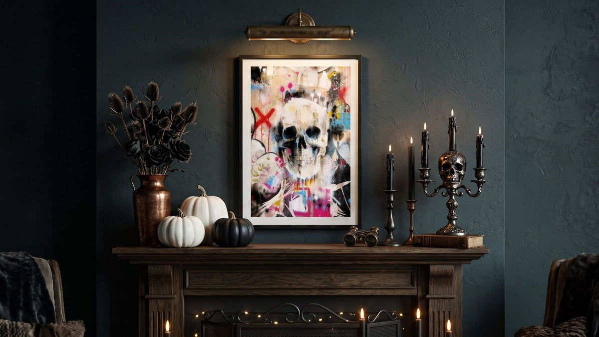 Halloween canvas wall art of a graffiti skull above a fireplace styled with pumpkins and candles